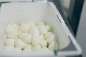 a container filled with white marshmallows sitting on top of a counter